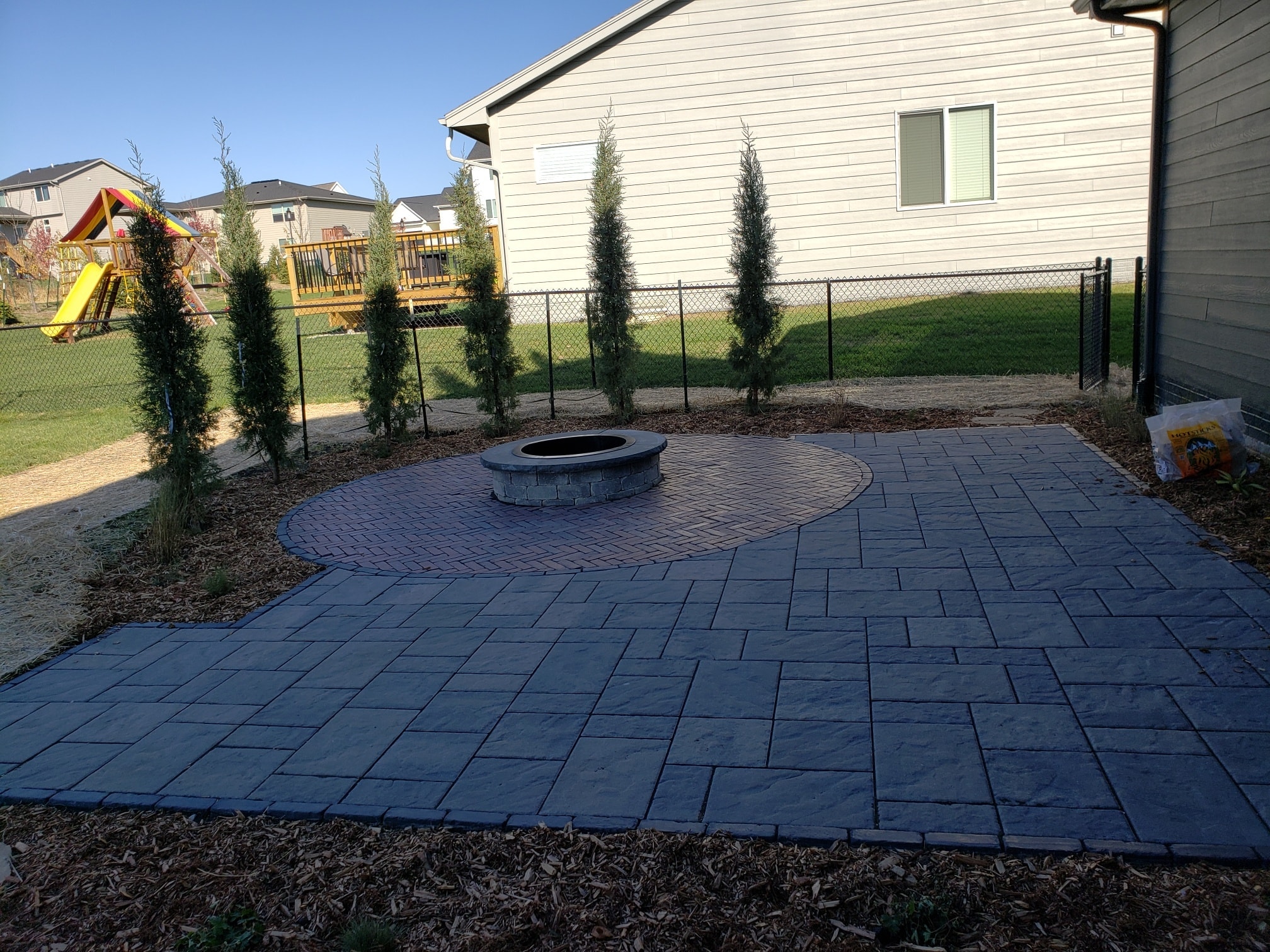 Full Patio with Stone Firepit and Tree Surround Norwalk Seasonal - Des Moines, Iowa